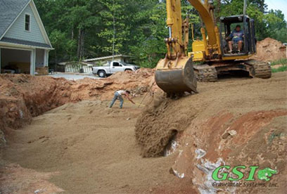 placing ASTM C-33 sand in bed area GSI is your source for septic system repair in Northeast Georgia